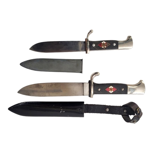 597 - A GERMAN WWII HITLER YOUTH DAGGER AND SCABBARD 
By Eickhorn along with a shorter version.

Condition... 