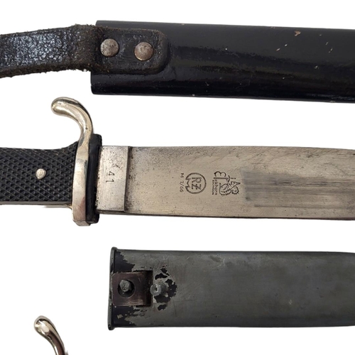 597 - A GERMAN WWII HITLER YOUTH DAGGER AND SCABBARD 
By Eickhorn along with a shorter version.

Condition... 