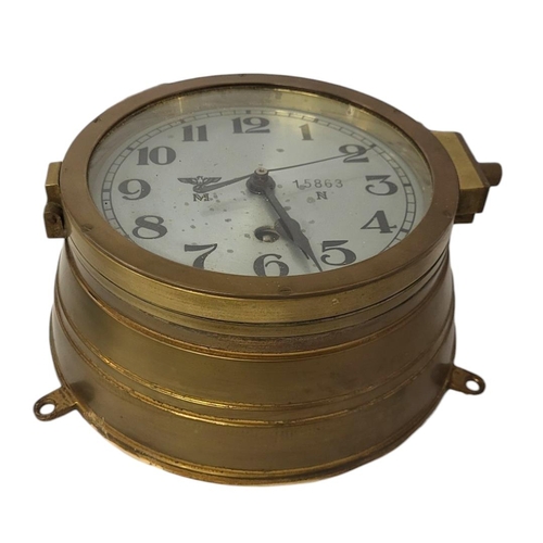 599 - A GERMAN WWII BRASS U-BOAT CLOCK
The silvered dial with spread eagle and engraved serial number 1586... 