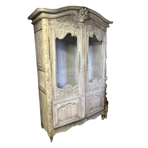 911 - A 19TH CENTURY FRENCH LIMED OAK ARMOIRE
Finely carved with floral bouquets and foliage, domed topped... 