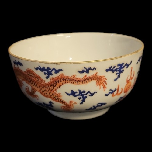 483 - A CHINESE PORCELAIN DRAGON BOWL
Hand painted with opposing dragons chasing a flaming pearl, bearing ... 