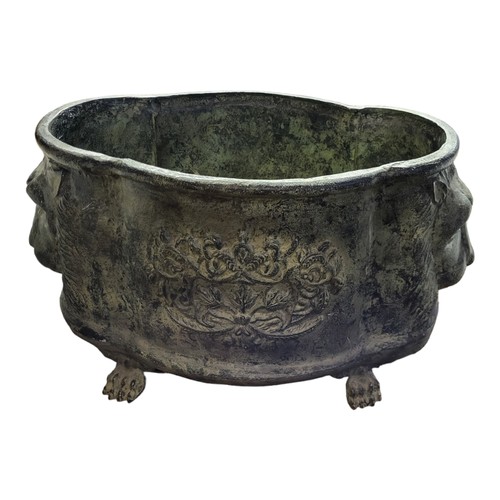 912 - A GREEN VERDIGRIS CAST ALUMINIUM PLANTER
Cartouche form with flower baskets and lion masks, on paw f... 