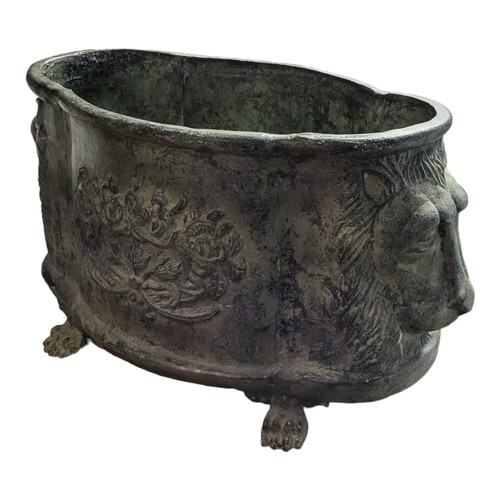 912 - A GREEN VERDIGRIS CAST ALUMINIUM PLANTER
Cartouche form with flower baskets and lion masks, on paw f... 