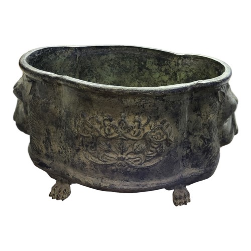 912 - A GREEN VERDIGRIS CAST ALUMINIUM PLANTER
Cartouche form with flower baskets and lion masks, on paw f... 