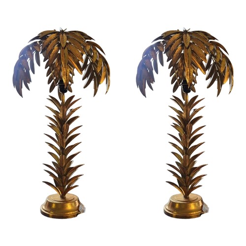 297 - A PAIR OF GILT METAL PALM TREE SIDE LAMPS AND SHADES
On a rounded pedestal base.
(38cm x 72cm)

Cond... 