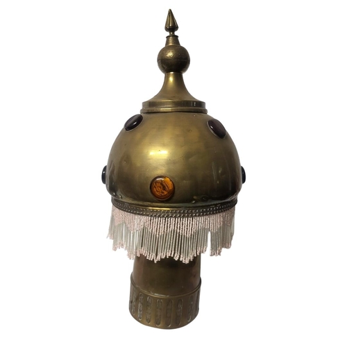 240A - AN EARLY 20TH CENTURY ARABESQUE DESIGN BRASS TABLE LAMP
Domed globular brass shade applied with eigh... 