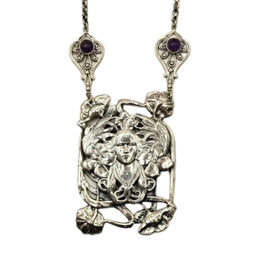 161 - AN ART NOUVEAU STYLE STERLING SILVER AMETHYST NECKLACE
The central portrait of a woman surrounded by... 