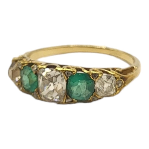 180 - A LATE 19TH/EARLY 20TH CENTURY YELLOW METAL, DIAMOND AND EMERALD FIVE STONE RING
Graduated old cut d... 