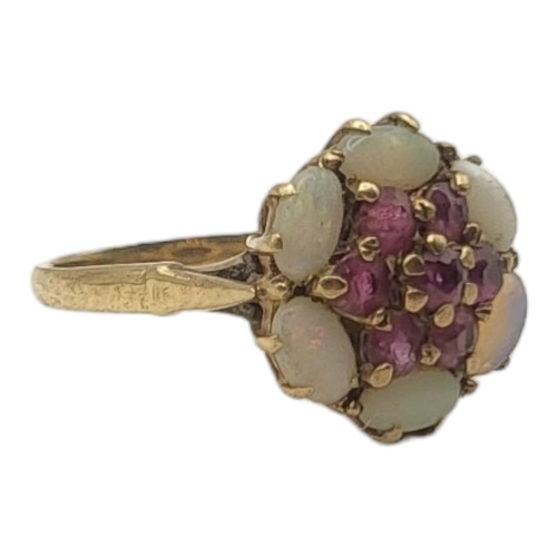 19A - AN EARLY 20TH CENTURY 9CT GOLD RUBY AND OPAL RING
The cluster of rubies edged with opals.
(size J)

... 