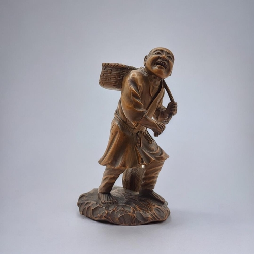 212 - A FINE JAPANESE MEIJI PERIOD, 1868 - 1911, WOODEN CARVING, FARM LABOURER
Wearing a Japanese provinci... 