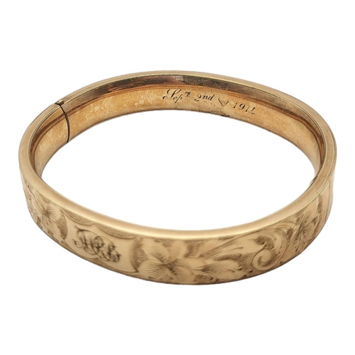 21A - AN EARLY 20TH CENTURY YELLOW METAL BANGLE
Having engraved floral decoration, inscribed September 2nd... 