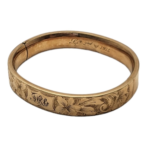 21A - AN EARLY 20TH CENTURY YELLOW METAL BANGLE
Having engraved floral decoration, inscribed September 2nd... 