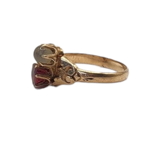 22 - AN EARLY 20TH CENTURY YELLOW METAL GARNET AND MOONSTONE RING
Having a round cut garnet and cabochon ... 