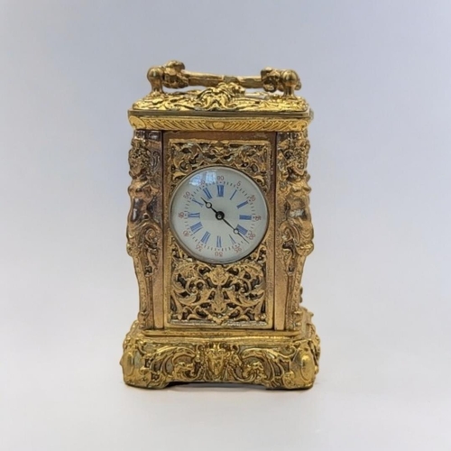 227 - A 19TH CENTURY ROCOCO STYLE GILT BRONZE MINI CARRIAGE CLOCK
Bevelled glass panel to the top revealin... 