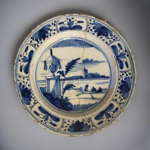 228 - AN 18TH CENTURY ENGLISH DELFTWARE BLUE AND WHITE TIN GLAZED EARTHENWARE CHARGER
The centre painted w... 