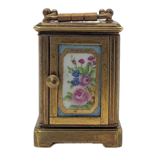 229 - A MINIATURE SÈVRES STYLE FRENCH PORCELAIN AND POLISHED BRASS CARRIAGE CLOCK
Having a glass top with ... 