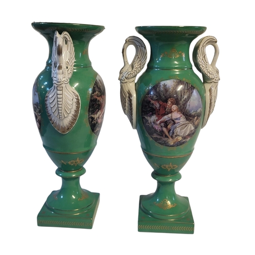 239 - A PAIR OF FRENCH SEVRES STYLE GREEN PORCELAIN URNS
In classic amphora form with swan neck handles an... 