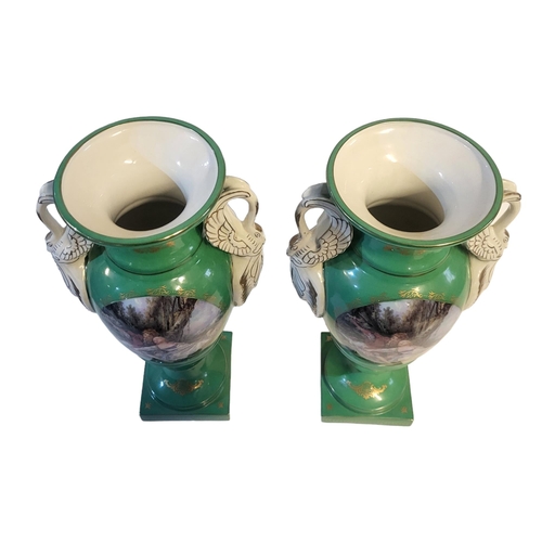 239 - A PAIR OF FRENCH SEVRES STYLE GREEN PORCELAIN URNS
In classic amphora form with swan neck handles an... 