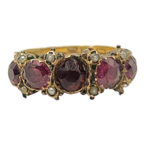 23A - A 19TH CENTURY YELLOW METAL, GARNET AND SEED PEARL RING
Having an arrangement of graduated stones in... 