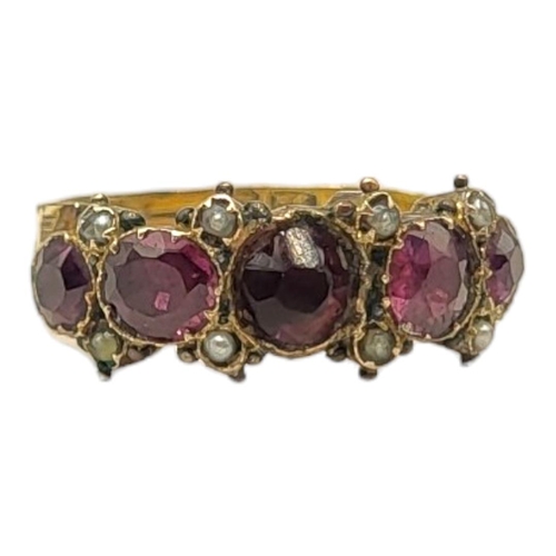 23A - A 19TH CENTURY YELLOW METAL, GARNET AND SEED PEARL RING
Having an arrangement of graduated stones in... 