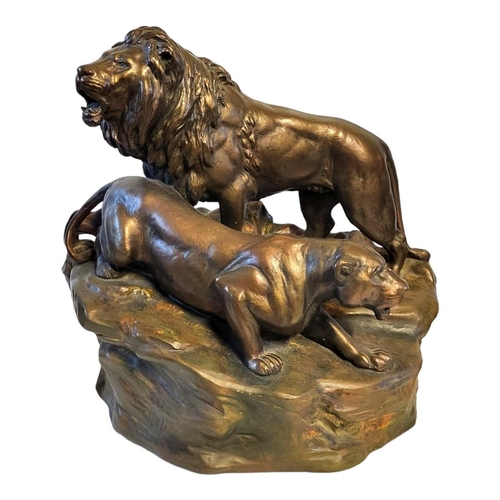 242 - AN EARLY 20TH CENTURY POTTERY LION AND LIONESS
Standing pose on textured base.
(approx 40cm)