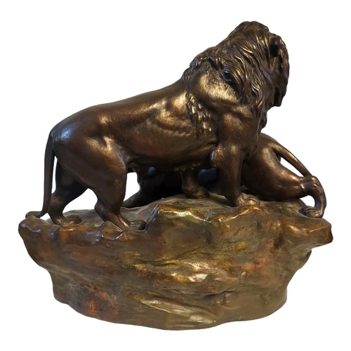 242 - AN EARLY 20TH CENTURY POTTERY LION AND LIONESS
Standing pose on textured base.
(approx 40cm)