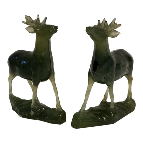 242B - A PAIR OF ORIENTAL SPINACH GREEN JADE CARVINGS OF STAGS
Carved and modelled in relief, with naturali... 