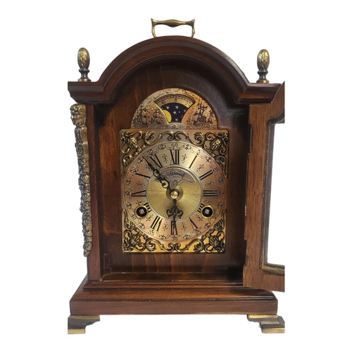 266A - WARMINK, A 20TH CENTURY MAHOGANY AND BRASS MANTEL CLOCK
Single brass handle with acorn finials and b... 