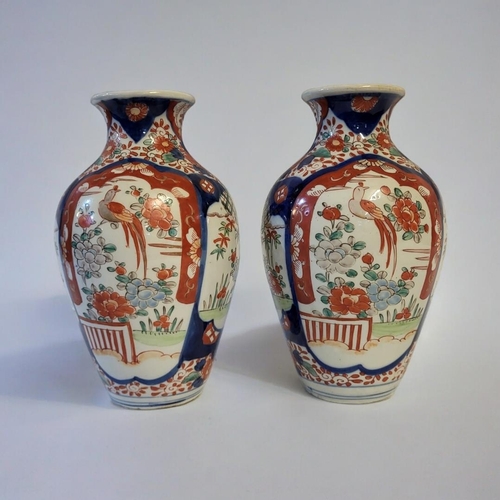 271 - A PAIR OF 18TH CENTURY JAPANESE IMARI STYLE VASES
Taking baluster form with painted floral decoratio... 