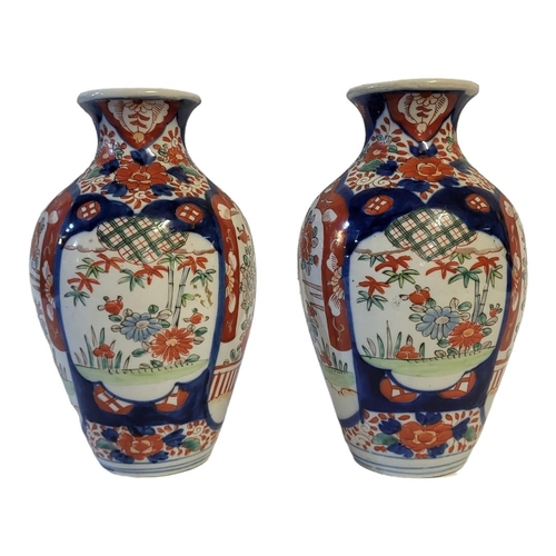 271 - A PAIR OF 18TH CENTURY JAPANESE IMARI STYLE VASES
Taking baluster form with painted floral decoratio... 