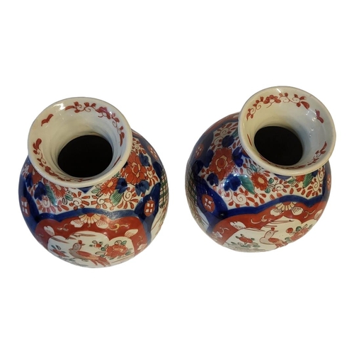 271 - A PAIR OF 18TH CENTURY JAPANESE IMARI STYLE VASES
Taking baluster form with painted floral decoratio... 