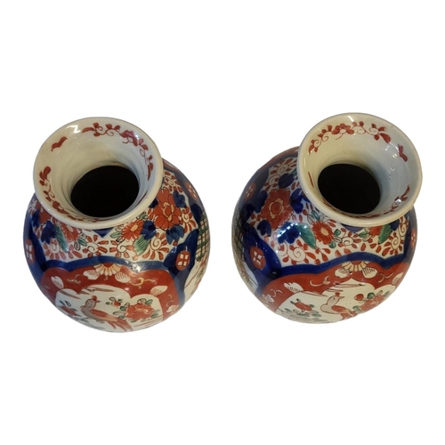 271 - A PAIR OF 18TH CENTURY JAPANESE IMARI STYLE VASES
Taking baluster form with painted floral decoratio... 