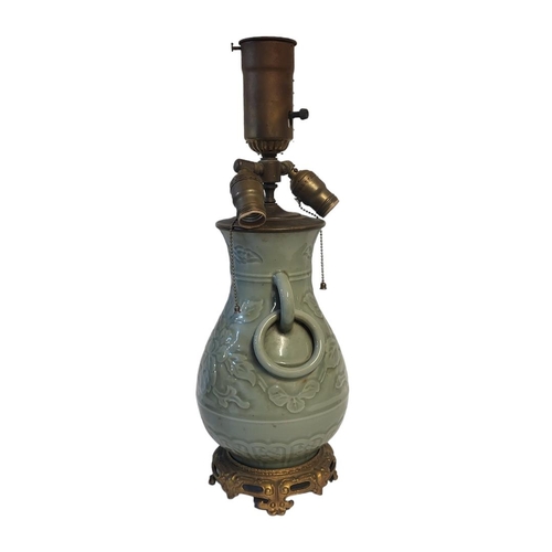 273 - A 19TH CENTURY STYLE BRASS AND CERAMIC CHINESE CELADON LAMP
With three light fixtures above an urn s... 