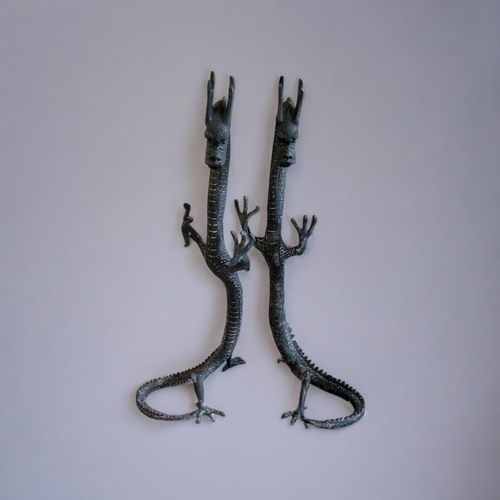 275 - A PAIR OF ORIENTAL STYLE BRONZE STANDING DRAGONS
With the curled tail as support. 
(19cm x 20cm x 40... 