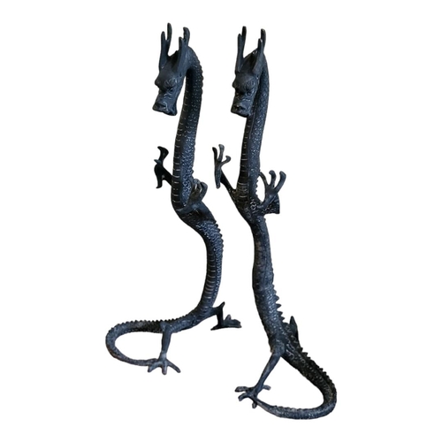 275 - A PAIR OF ORIENTAL STYLE BRONZE STANDING DRAGONS
With the curled tail as support. 
(19cm x 20cm x 40... 