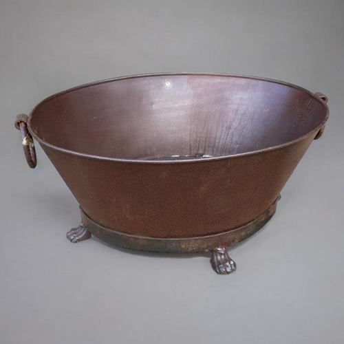 281 - A CAST IRON OVAL WINE COOLER
With ring handles on a tapering body, terminating on paw feet. 
(75cm x... 