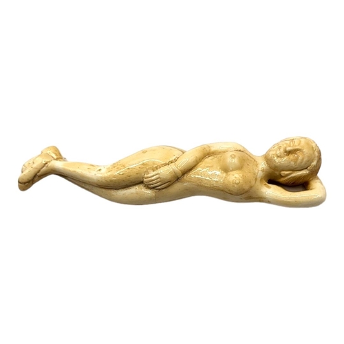 304 - A 19TH CENTURY CHINESE STYLE BONE DOCTORS FIGURE
Nude woman lying in recumbent position. 
(13cm)

Co... 