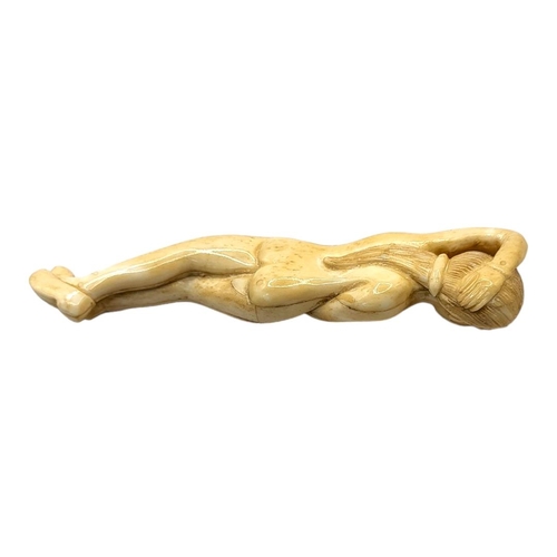 304 - A 19TH CENTURY CHINESE STYLE BONE DOCTORS FIGURE
Nude woman lying in recumbent position. 
(13cm)

Co... 