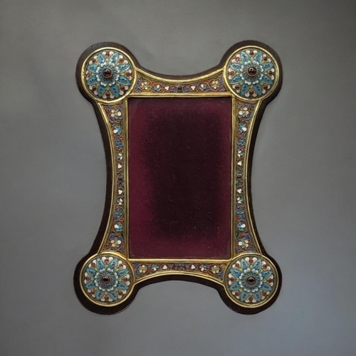 310 - A RUSSIAN STYLE ENAMEL AND GILT METAL WORK PICTURE FRAME
Borders having floral decoration and caboch... 