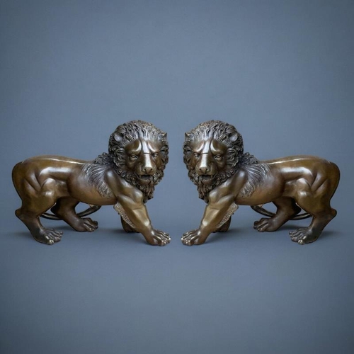 312 - A PAIR OF JAPANESE STYLE BRONZE LIONS
In the manner of the Meiji period, facing opposing directions.... 