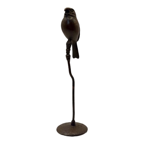 314 - A JAPANESE SHŌWA STYLE BRONZE SINGING BIRD
Perched on a branch with impressed foundry mark on rounde... 