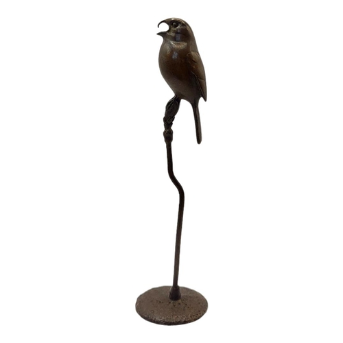 314 - A JAPANESE SHŌWA STYLE BRONZE SINGING BIRD
Perched on a branch with impressed foundry mark on rounde... 