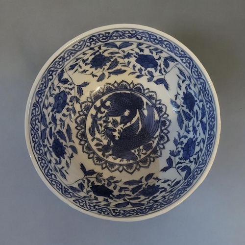 317 - A 19TH CENTURY CHINESE STYLE  BLUE AND WHITE FOOTED BOWL
With entwined phoenix and lotus decoration,... 