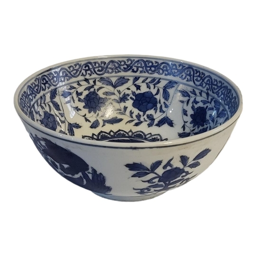 317 - A 19TH CENTURY CHINESE STYLE  BLUE AND WHITE FOOTED BOWL
With entwined phoenix and lotus decoration,... 