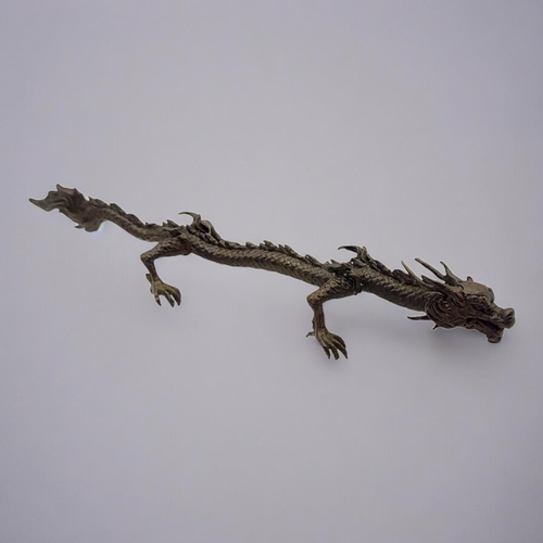 320 - A JAPANESE STYLE BRONZE DRAGON
Balanced on all four feet with flaming tail. 
(15.5cm)

Condition: go... 