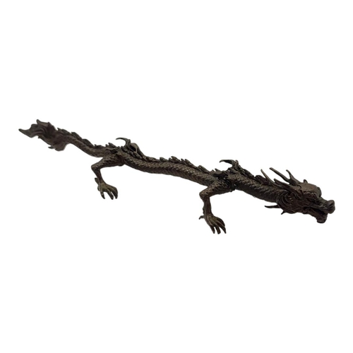 320 - A JAPANESE STYLE BRONZE DRAGON
Balanced on all four feet with flaming tail. 
(15.5cm)

Condition: go... 