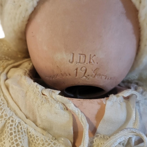 329 - A.J.D. KESTNER, A BISQUE HEADED BABY DOLL 
With magnesite head, open and close painted eyes and open... 