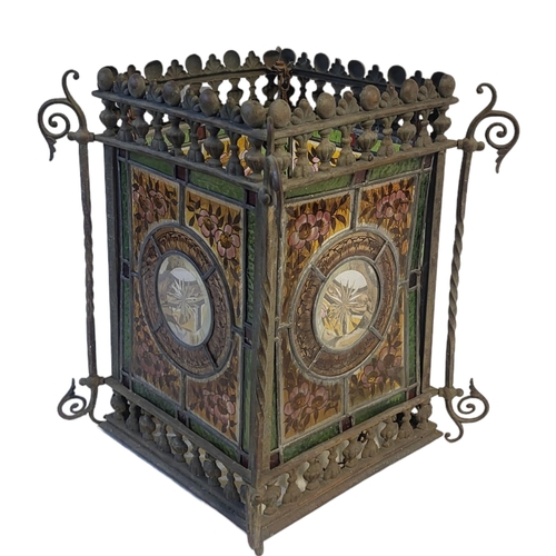 341 - A VICTORIAN AESTHETIC MOVEMENT STAINED GLASS AND METAL LANTERN
Four coloured glass panels within a g... 