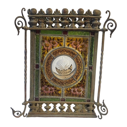 341 - A VICTORIAN AESTHETIC MOVEMENT STAINED GLASS AND METAL LANTERN
Four coloured glass panels within a g... 