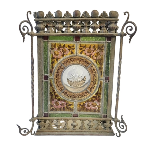 341 - A VICTORIAN AESTHETIC MOVEMENT STAINED GLASS AND METAL LANTERN
Four coloured glass panels within a g... 